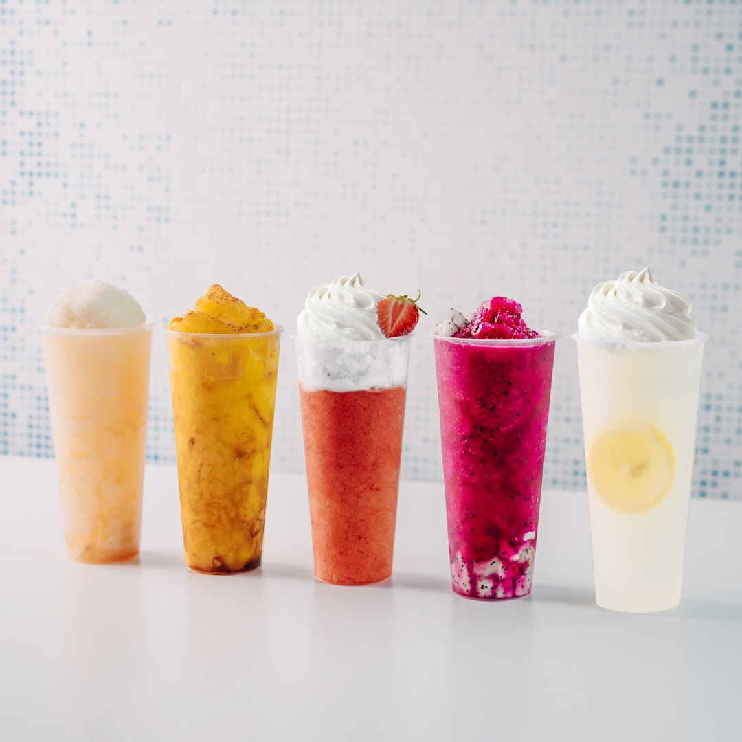 Five vibrant fruit smoothies and lemonades in clear cups with a light background.