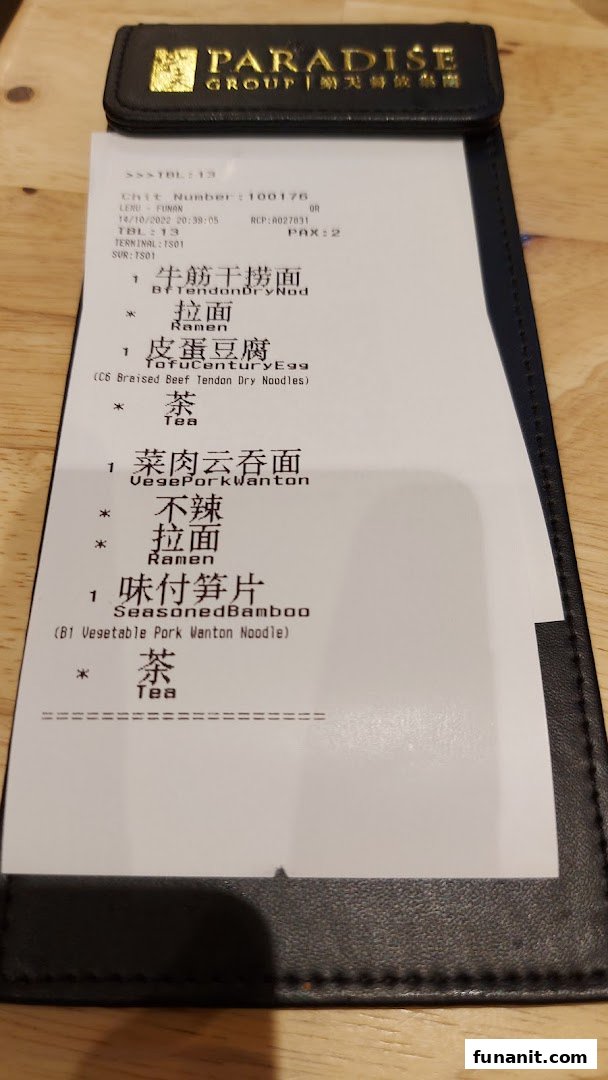 A close-up of an order chit from LeNu Chefs Wai Noodle Bar, showing ordered items.