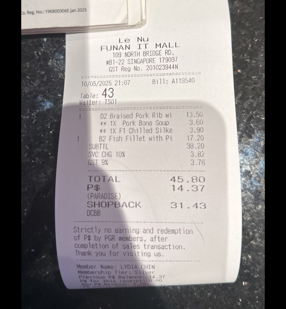 A detailed receipt from Le Nu at Funan IT Mall showing food items and total cost.