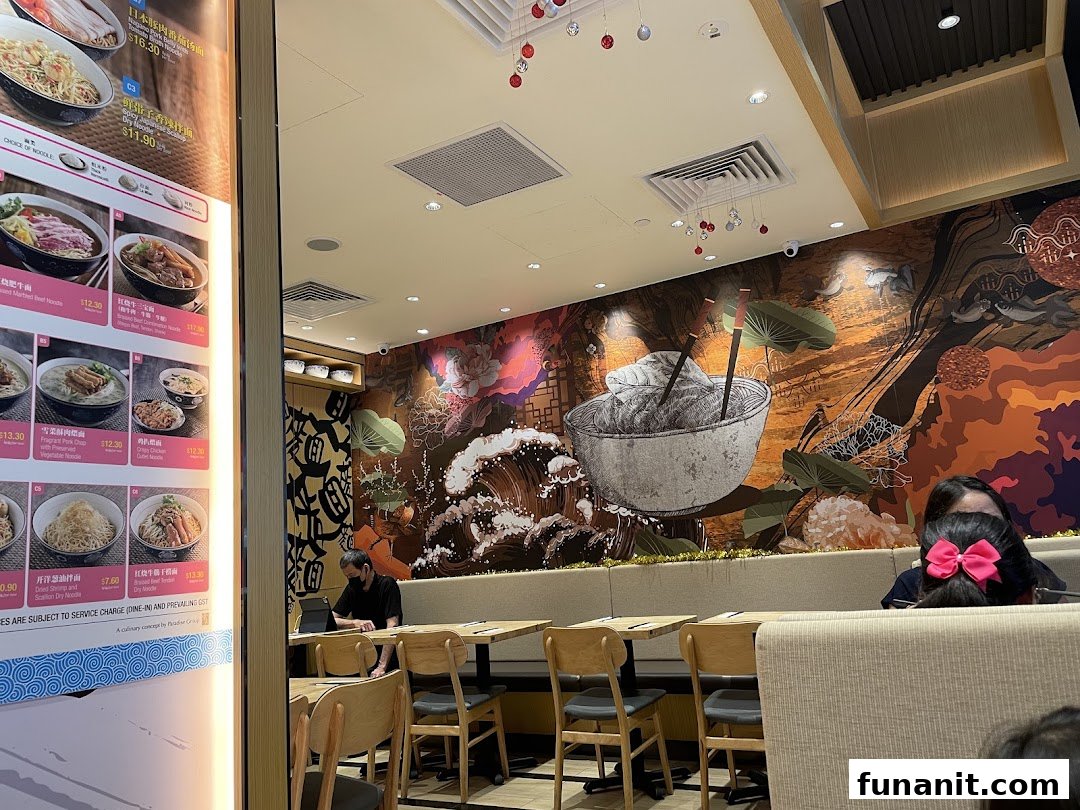 Interior view of LeNu Chefs Wai Noodle Bar, featuring a vibrant wall mural and comfortable seating.