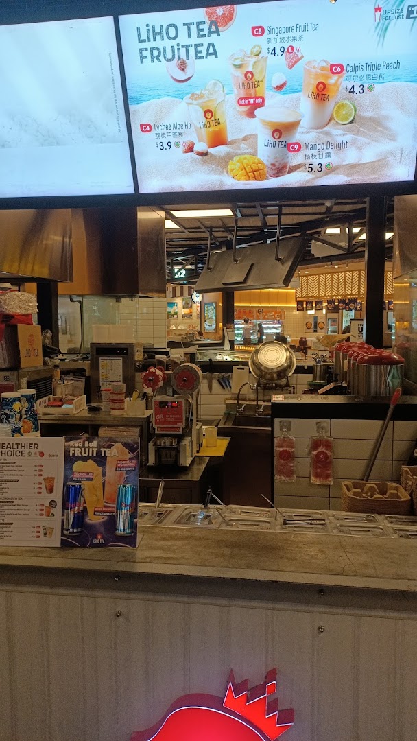 A vibrant LiHO TEA counter with a digital menu displaying refreshing fruit tea options.
