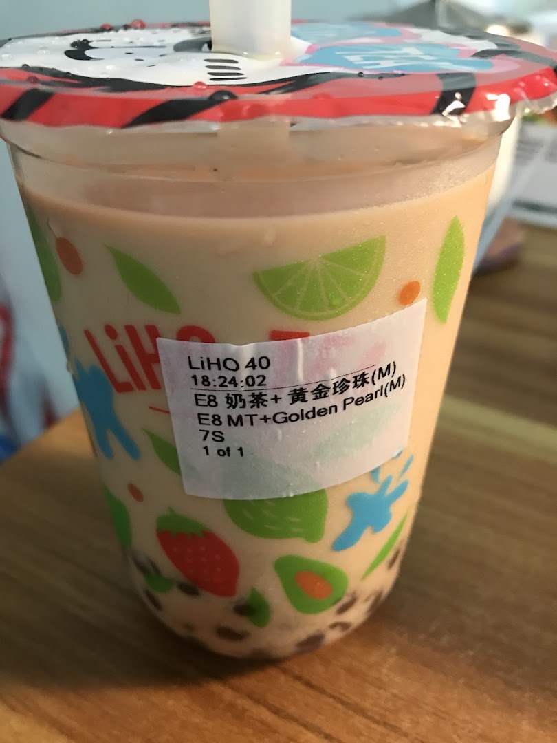 A close-up of a LiHO TEA bubble tea drink with a product label, featuring a colorful cup design.