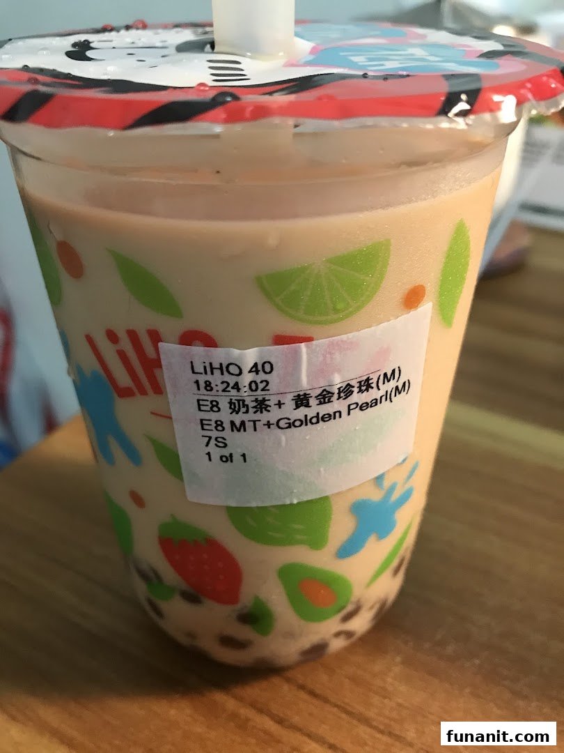 A close-up of a LiHO TEA bubble tea drink with a product label, featuring a colorful cup design.