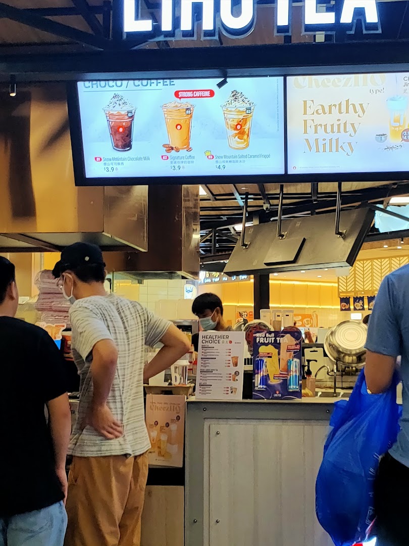 Digital menu boards at LiHO TEA displaying coffee and chocolate drinks with prices.