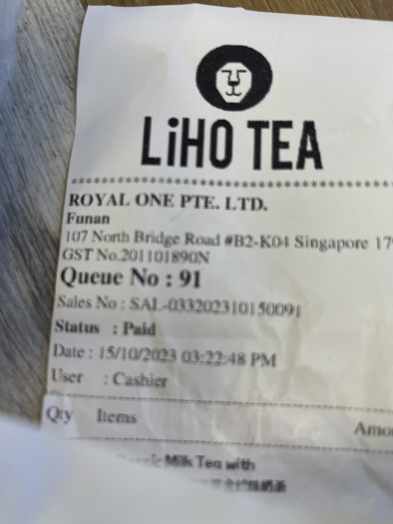 A close-up view of a LiHO TEA receipt showing transaction details and store information.