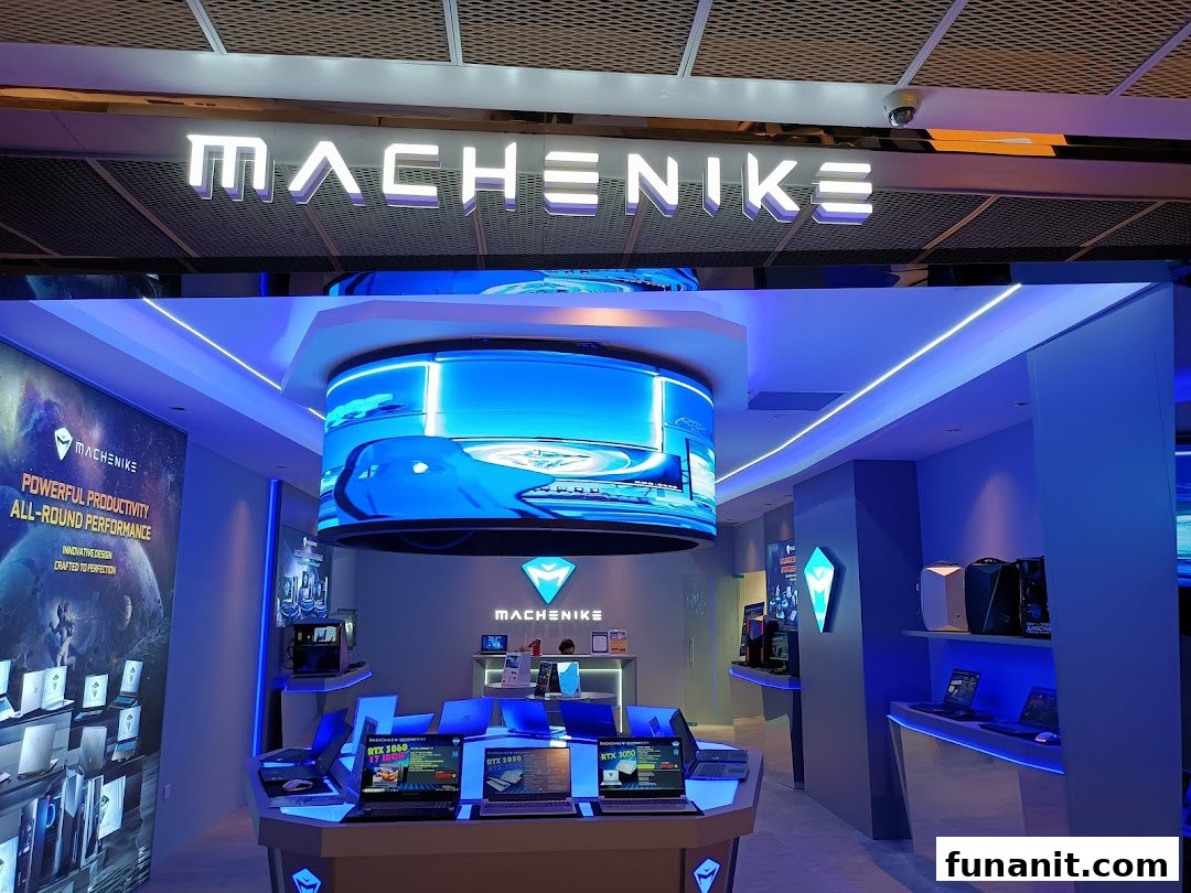 Interior view of the Machenike Experience Store showcasing gaming laptops, PCs, and a large curved display.