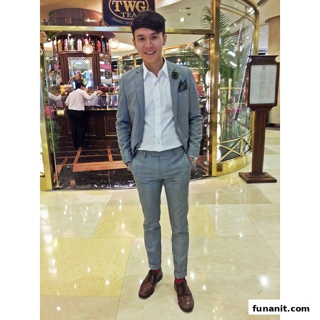 A stylish individual poses in front of the elegant TWG Tea salon entrance.