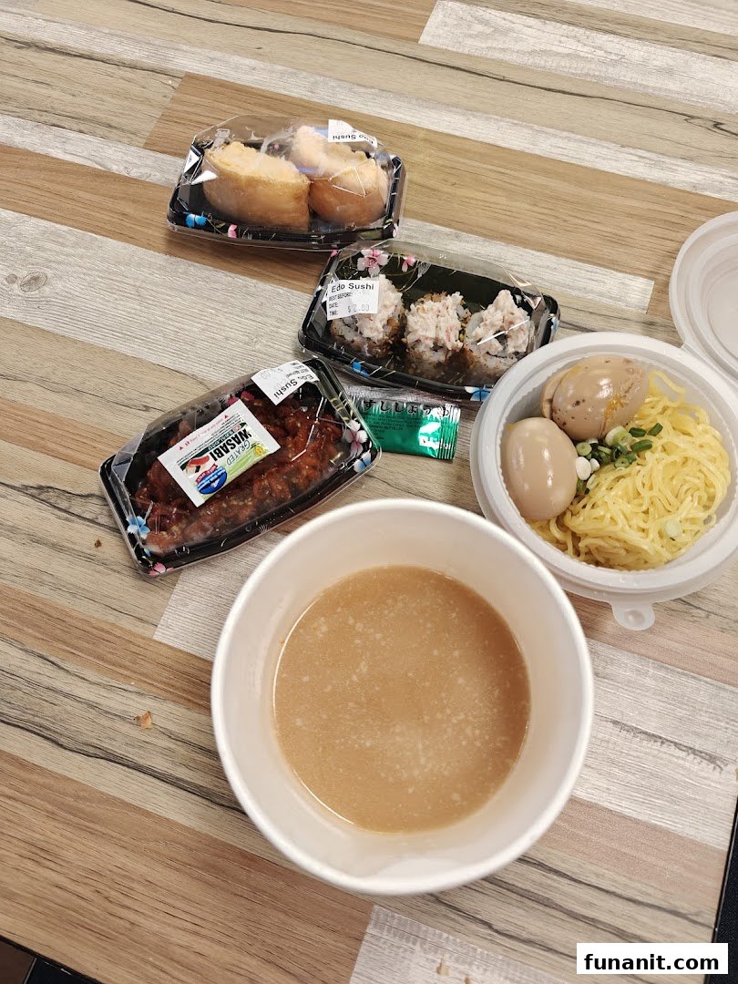 An assortment of delicious Japanese takeout, including sushi, noodles with eggs, and a savory soup.