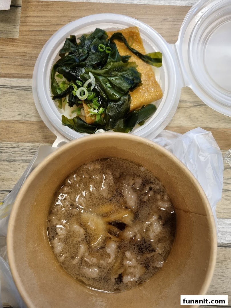 Two containers of prepared food, one with seaweed and tofu, the other with a savory soup.