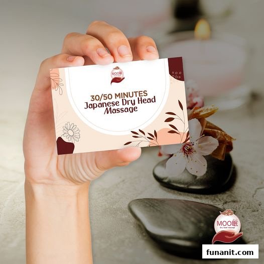 A hand holds a card advertising 30/50 minutes Japanese Dry Head Massage services.
