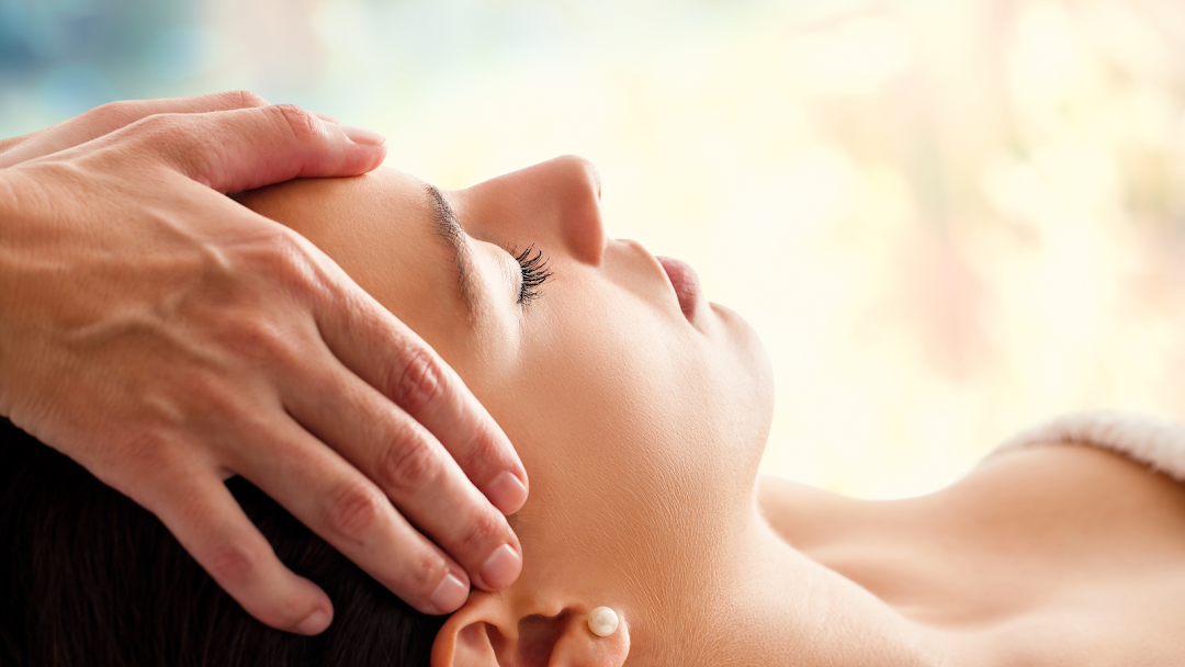 A person receiving a relaxing head massage, highlighting the soothing experience offered.