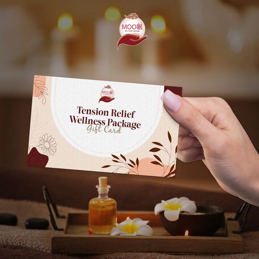 A hand holds a 'Tension Relief Wellness Package Gift Card' from Moomin Deep Sleep.