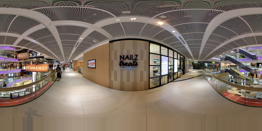 The modern exterior of Nailz Treats, a nail salon, located within the Funan shopping mall.