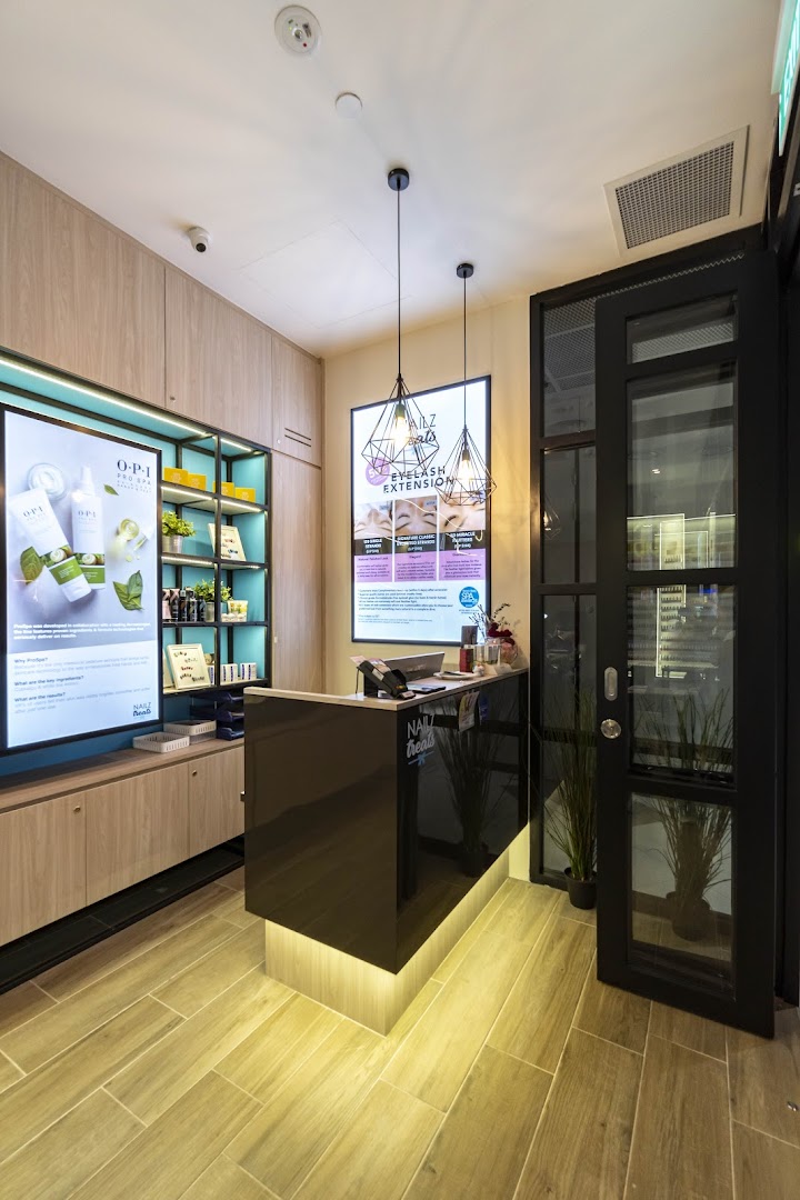 A modern and inviting reception area of Nailz Treats, featuring a sleek counter and product displays.