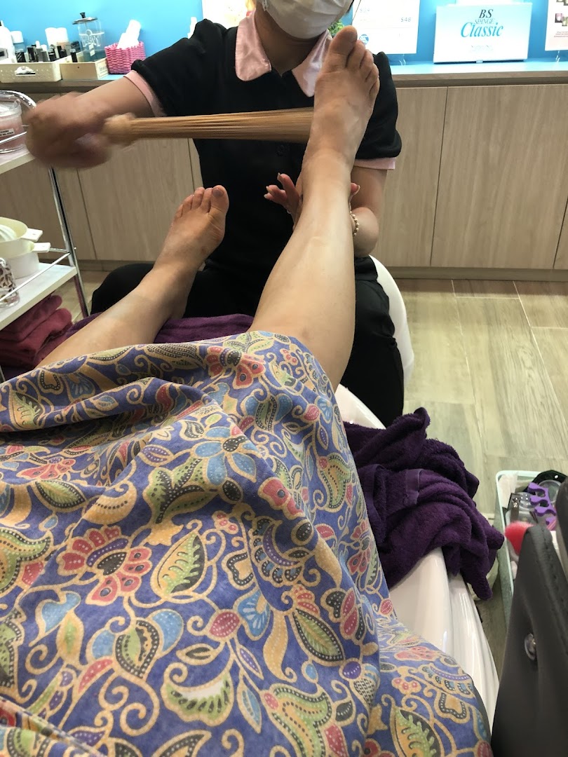 A customer receives a relaxing foot treatment from a therapist at Nailz Treats.