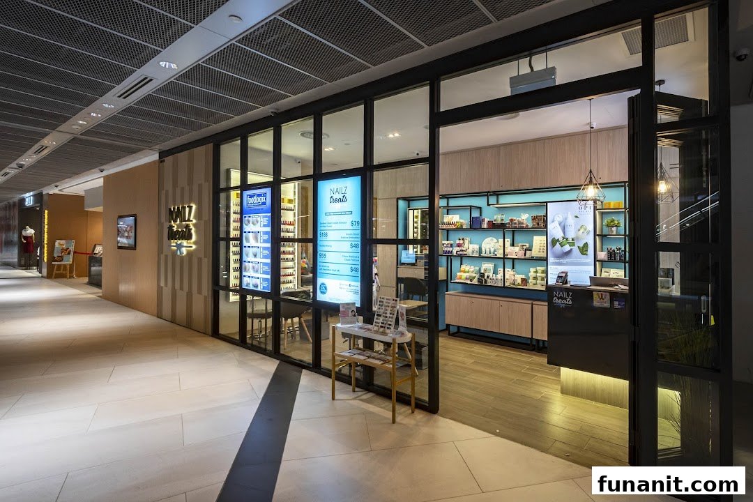 The brightly lit entrance of Nailz Treats salon, showcasing its modern interior and service displays from the mall corridor.