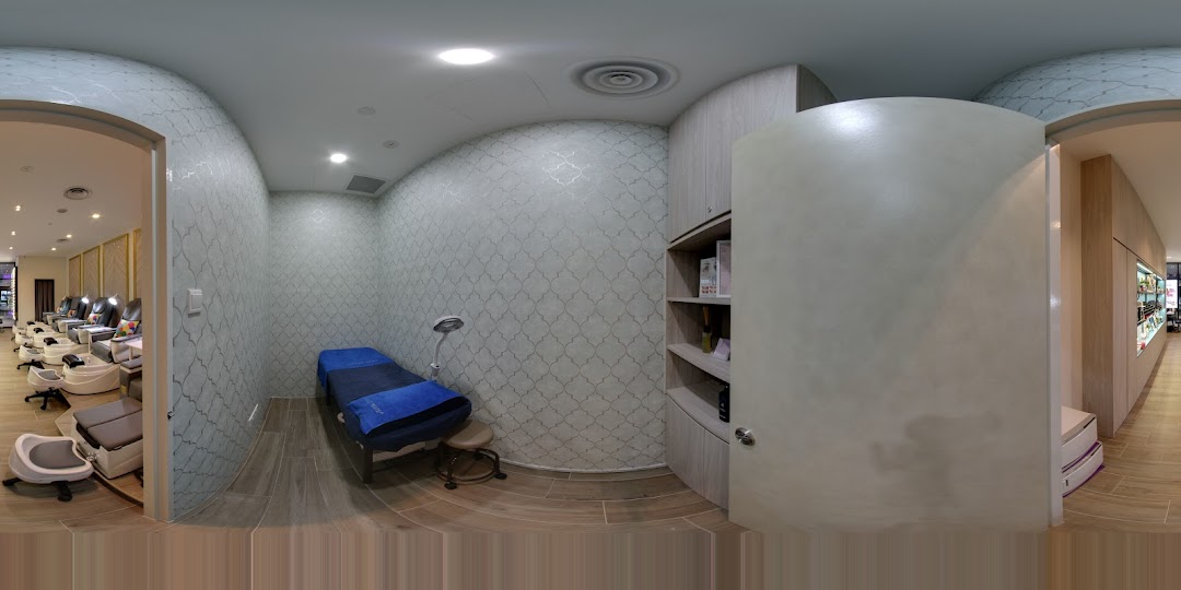 Interior view of a modern nail salon featuring pedicure stations and a private treatment room.