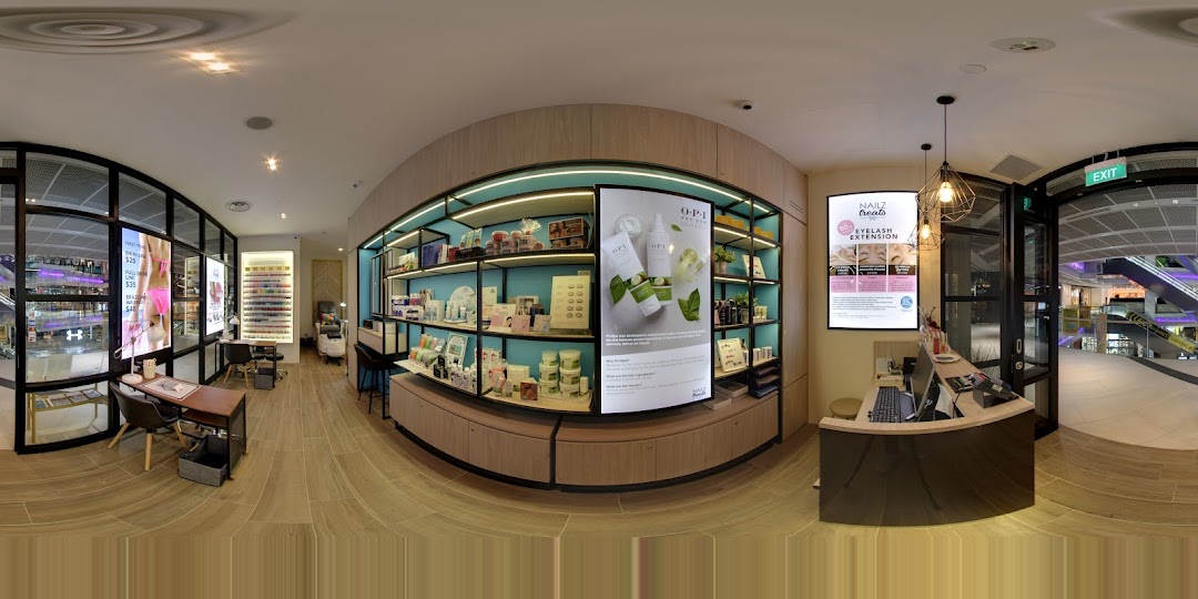 An interior view of Nailz Treats, showcasing the reception, product displays, and nail service stations.