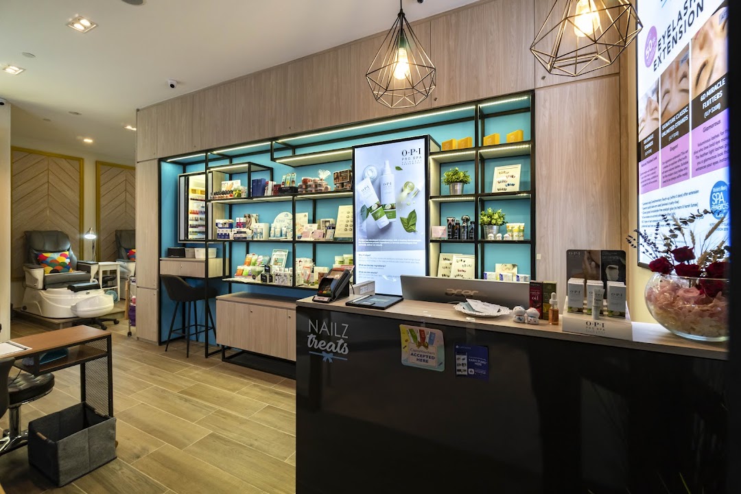 Interior view of Nailz Treats, showcasing the reception, product displays, and a pedicure station.