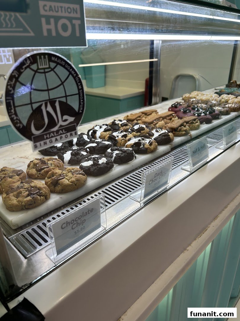 A display case showcasing a variety of freshly baked cookies with visible price tags.