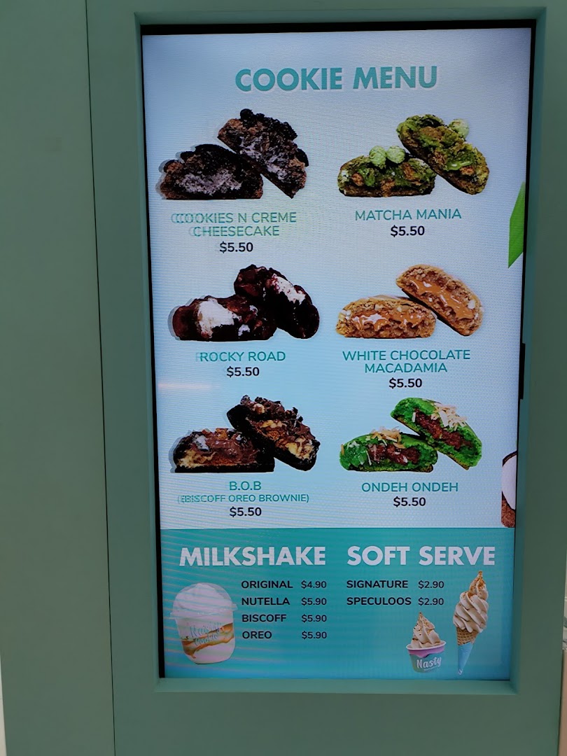 Digital menu board displaying cookies, milkshakes, and soft serve options with prices.