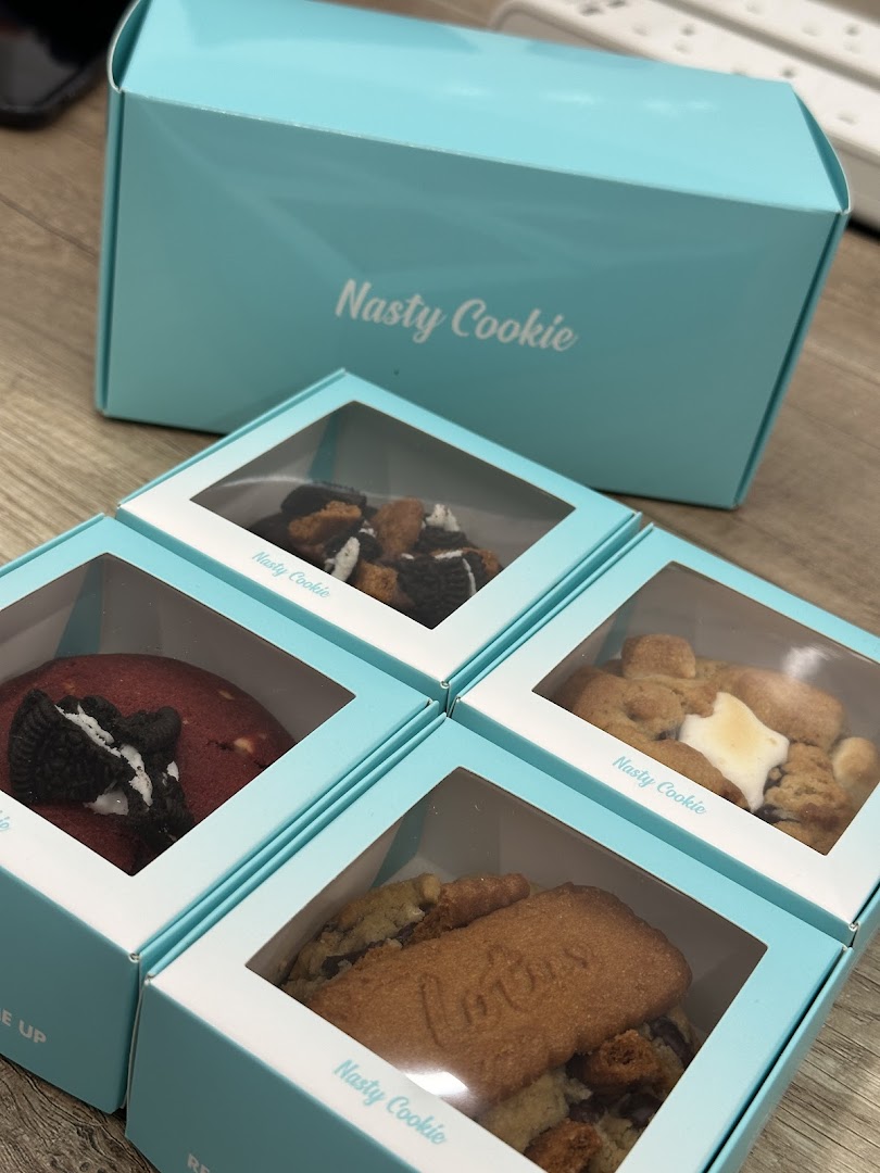 Assorted Nasty Cookie treats in individual boxes and a larger branded box.