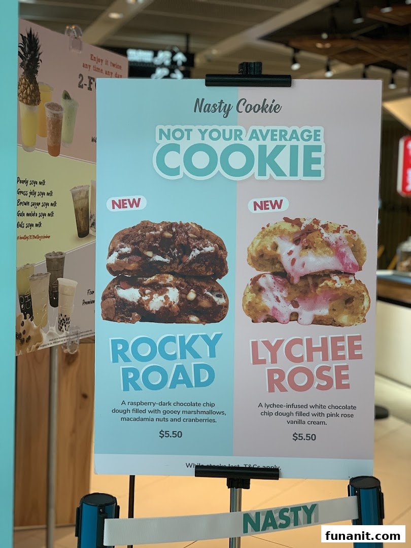 A display board showcasing Nasty Cookie's new Rocky Road and Lychee Rose cookie flavors with prices.