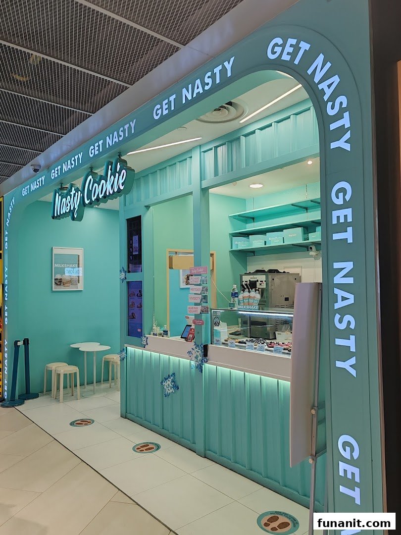 Vibrant teal shopfront of Nasty Cookie, showcasing its inviting entrance and signature branding.