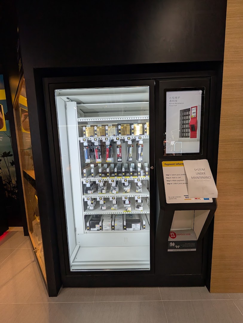 A Nikon Experience Hub vending machine displaying camera accessories and products for sale.