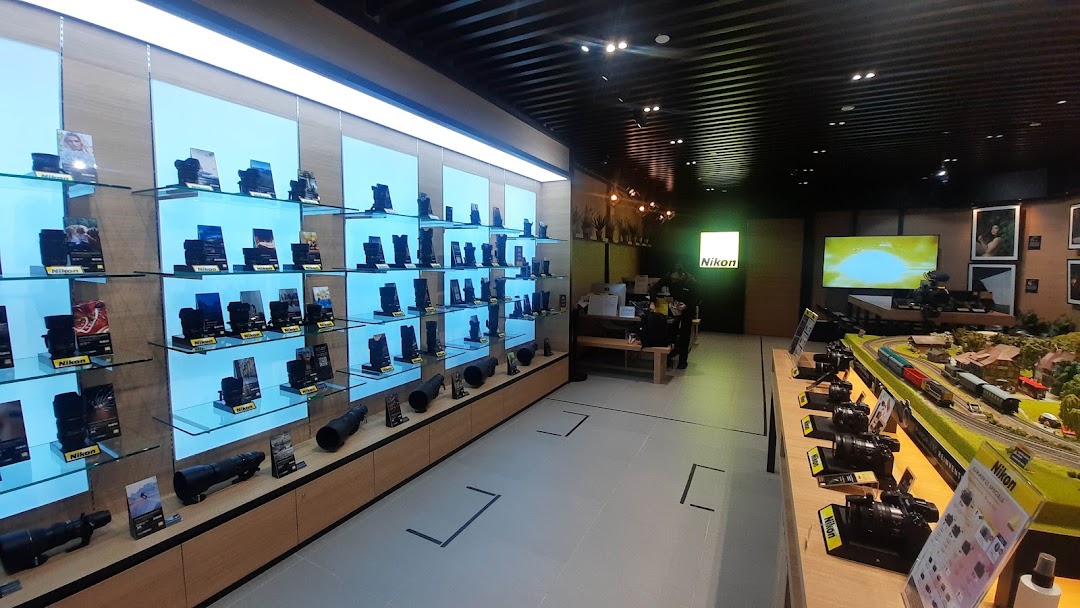 Interior view of the Nikon Experience Hub showcasing cameras, lenses, and a miniature display.