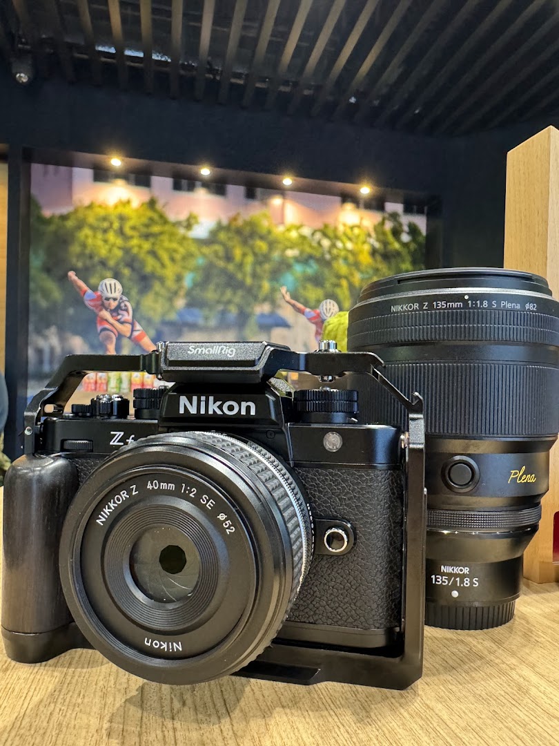 A close-up of a Nikon Zf camera with a NIKKOR Z 40mm lens and a NIKKOR Z 135mm Plena lens.
