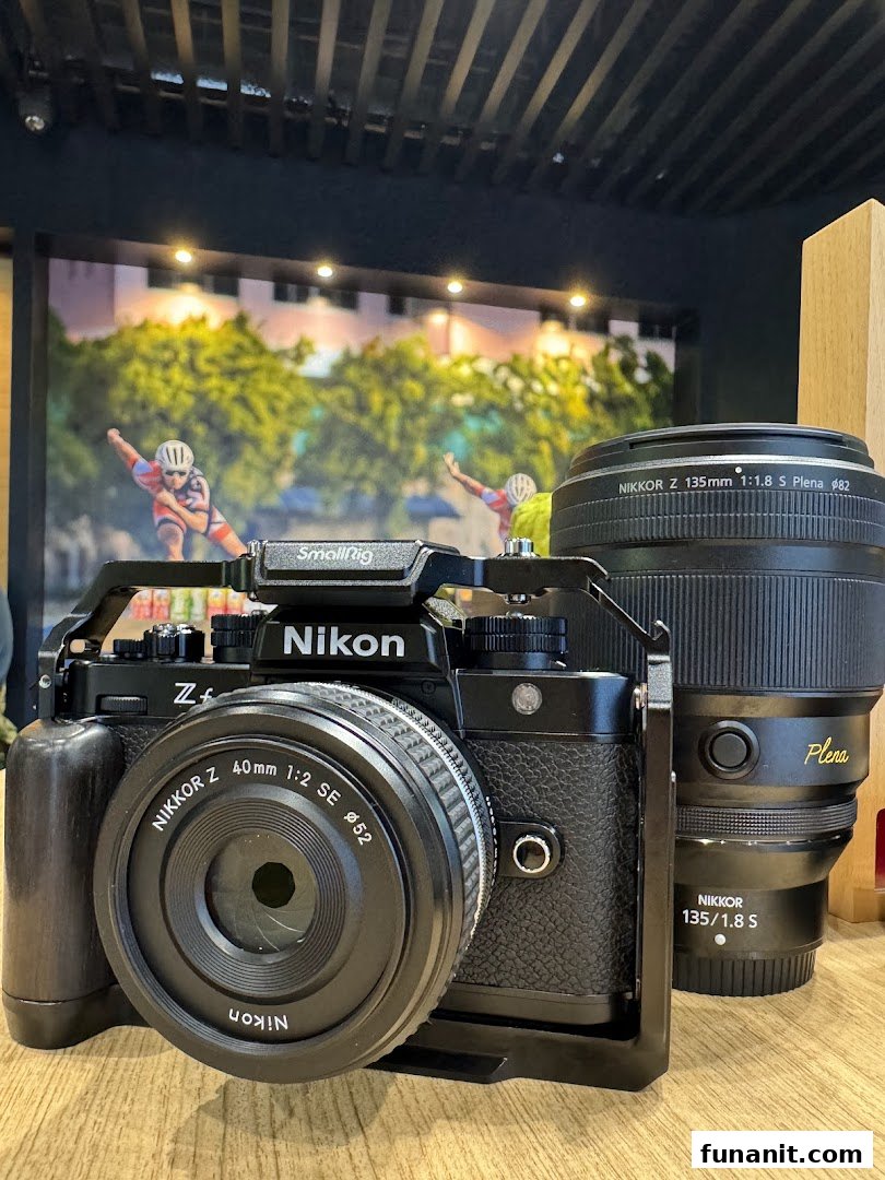 A close-up of a Nikon Zf camera with a NIKKOR Z 40mm lens and a NIKKOR Z 135mm Plena lens.
