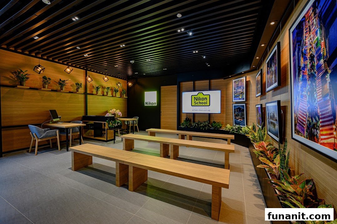 Interior view of Nikon Experience Hub, featuring a learning space with benches, tables, and photo displays.