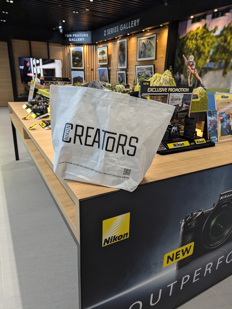 Interior view of Nikon Experience Hub Singapore, showcasing cameras, displays, and a 'Z Series Gallery'.