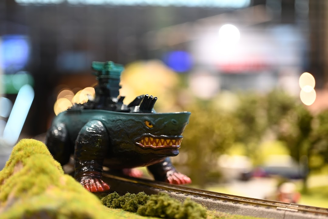 A detailed miniature monster vehicle on a model train track, showcasing intricate craftsmanship.