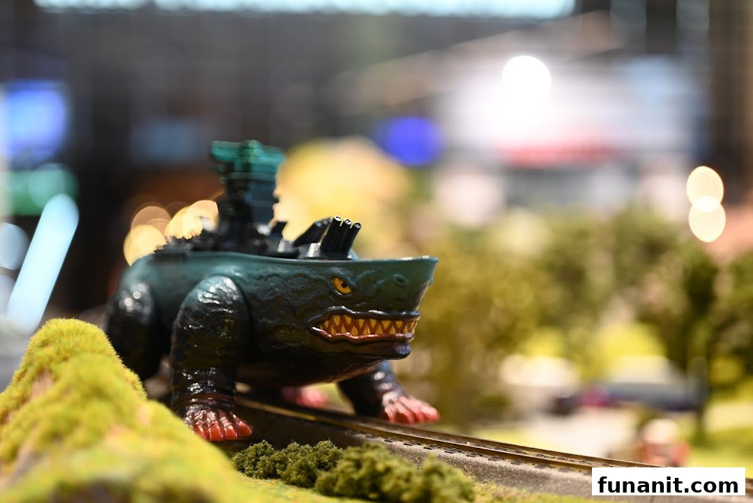 A detailed miniature monster vehicle on a model train track, showcasing intricate craftsmanship.