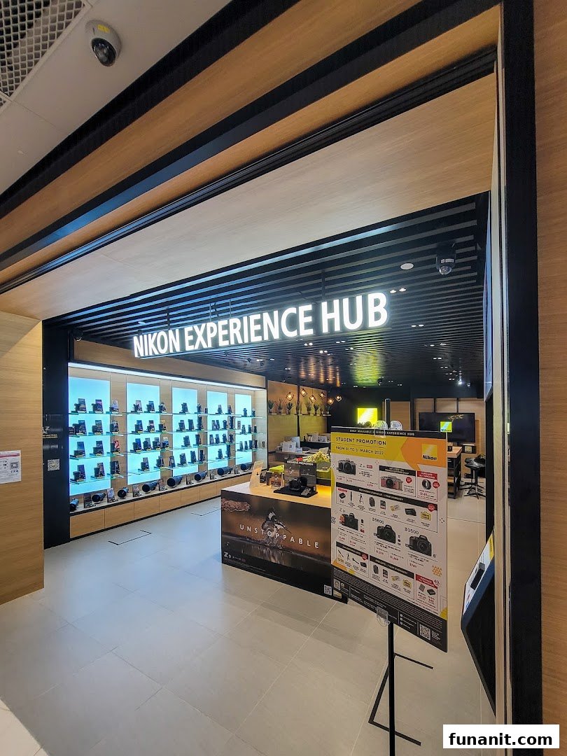 The entrance of the Nikon Experience Hub Singapore, showcasing cameras and accessories on display.