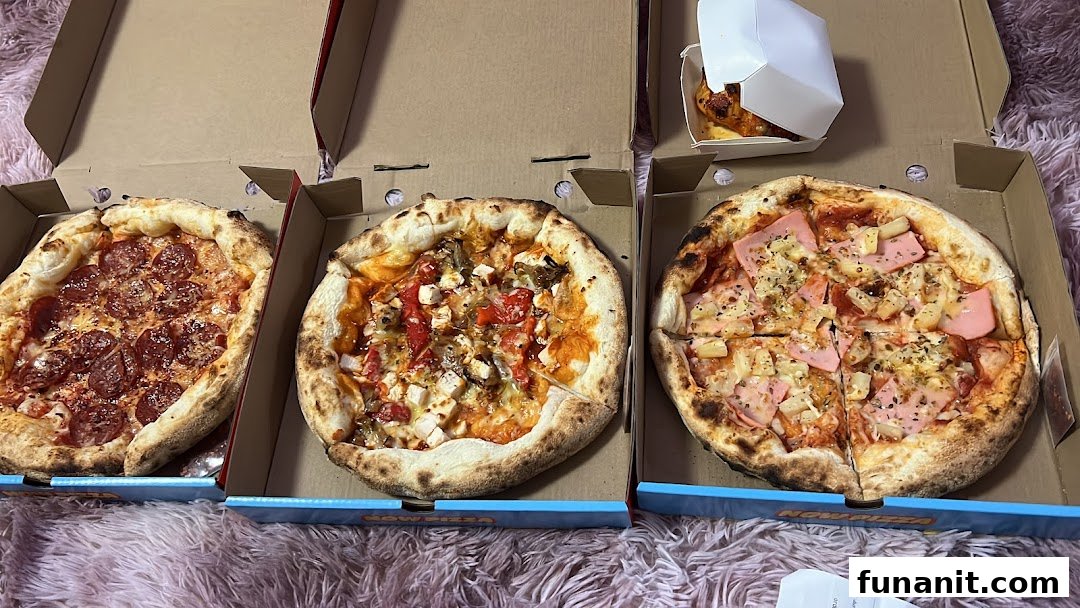 Three delicious pizzas and a side dish in takeout boxes from Now Pizza.