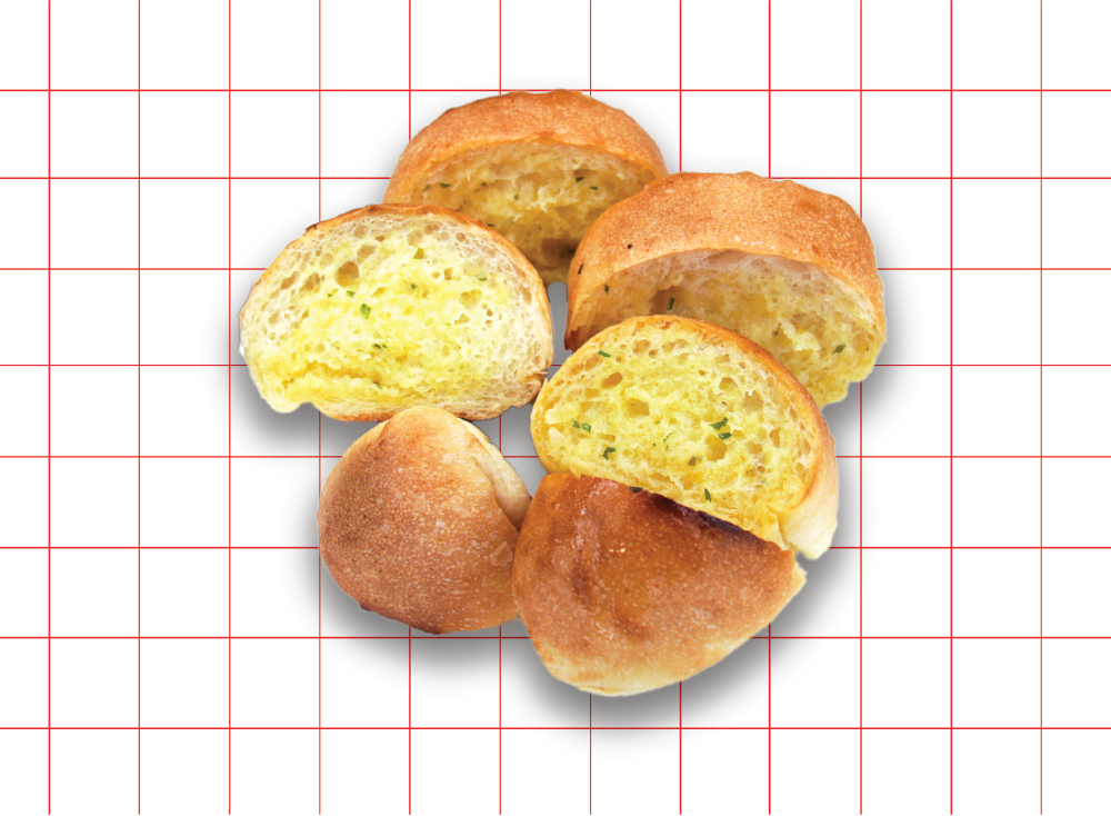 A close-up of several golden-brown garlic bread rolls, some sliced to reveal their buttery, herb-infused interior.