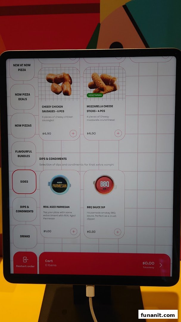 A digital self-ordering kiosk displaying menu items, prices, and categories for Now Pizza.