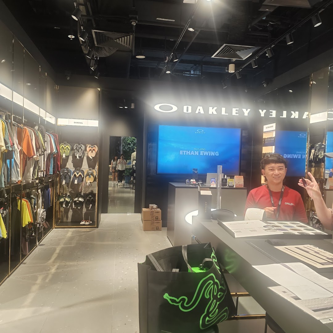 Interior view of Oakley Funan store showcasing apparel, footwear, and a staff member at the counter.