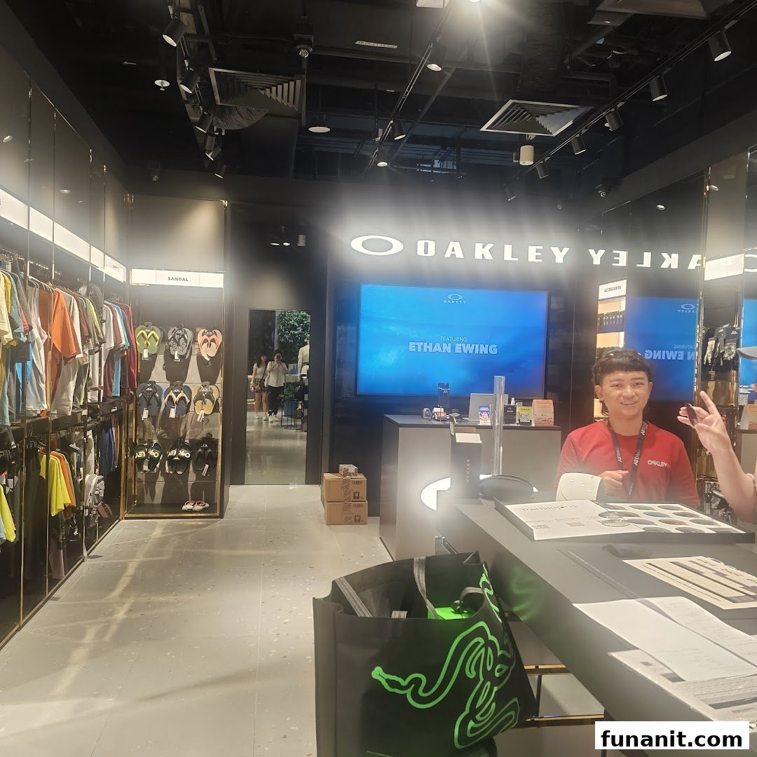 Interior view of Oakley Funan store showcasing apparel, footwear, and a staff member at the counter.