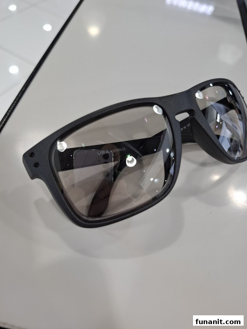 A close-up of a pair of black-framed Oakley sunglasses with clear lenses on display.