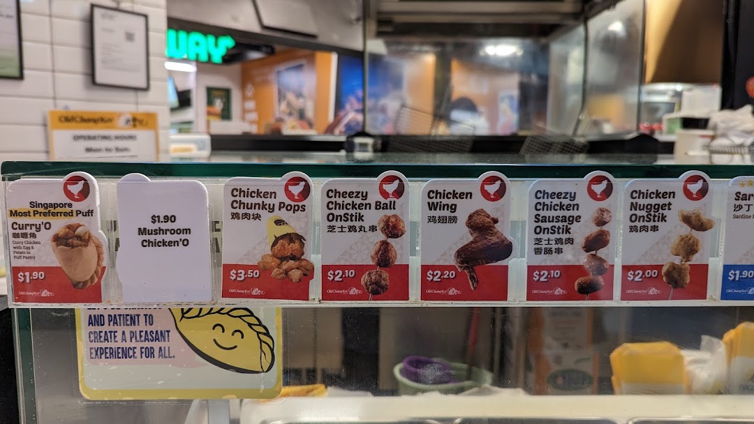 A close-up view of Old Chang Kee's display counter showcasing various fried snacks and their prices.