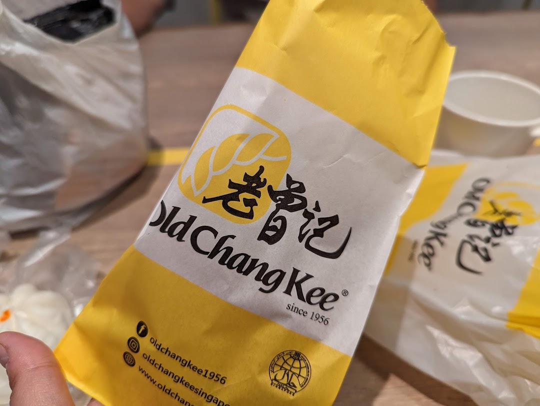 Close-up of Old Chang Kee branded packaging, featuring its logo and social media handles.