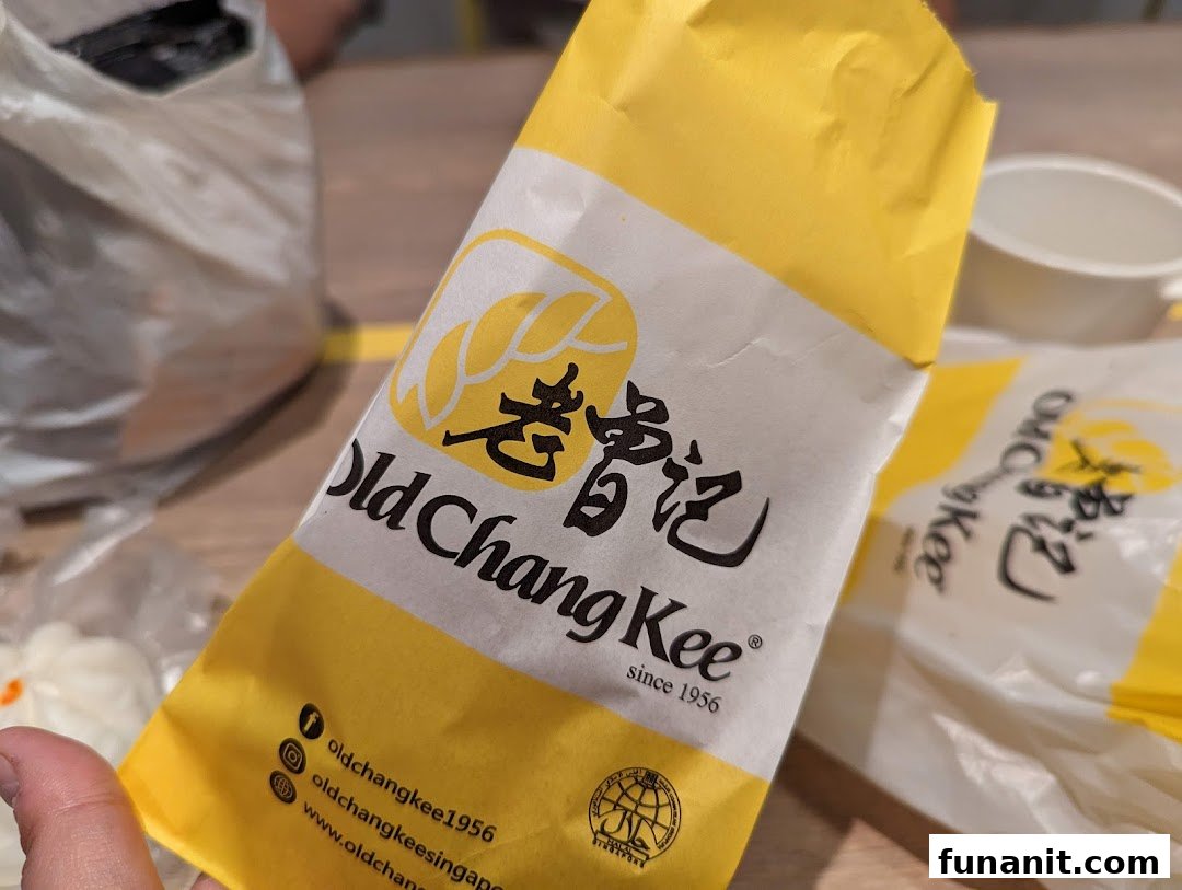 Close-up of Old Chang Kee branded packaging, featuring its logo and social media handles.