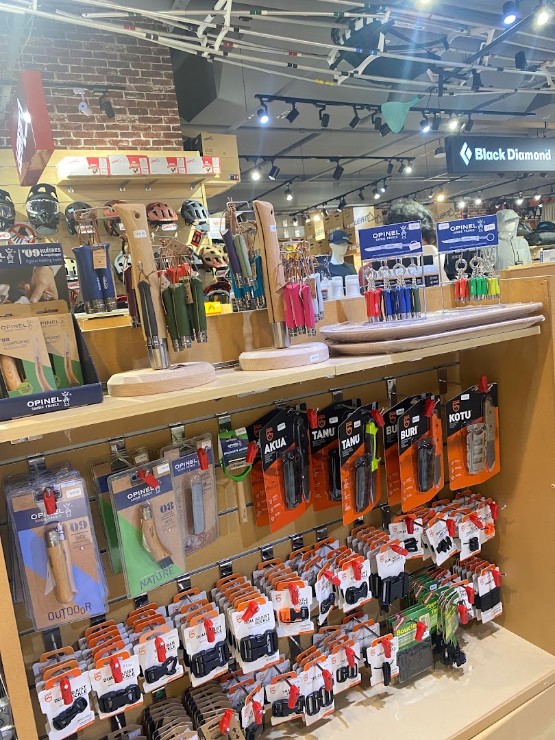 Interior view of Outdoor Life showcasing a wide range of outdoor gear, including knives, buckles, and helmets.