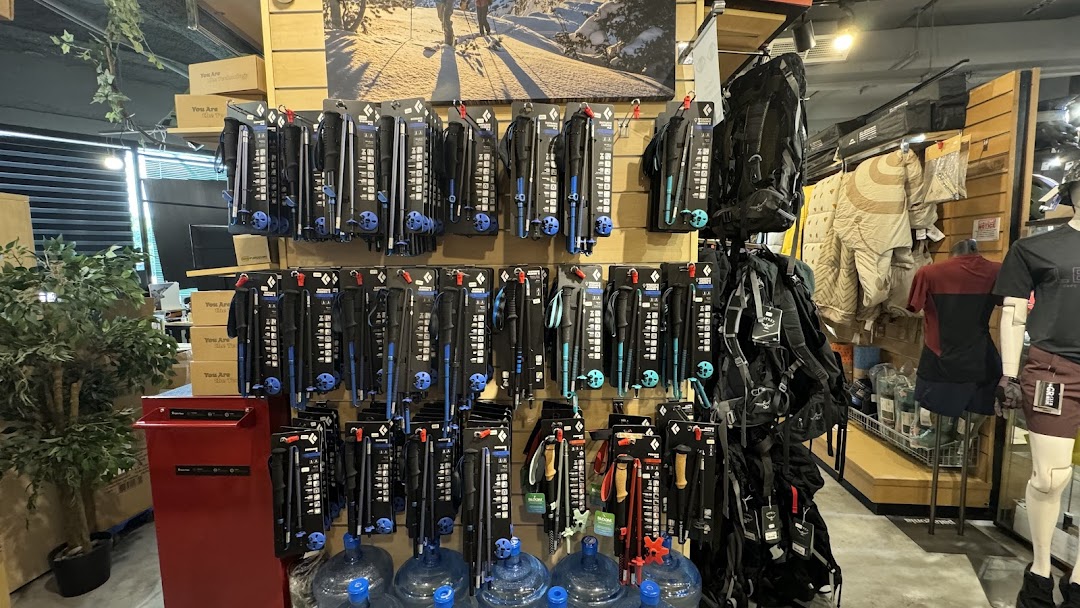 Interior view of Outdoor Life showcasing trekking poles, backpacks, and outdoor apparel displays.