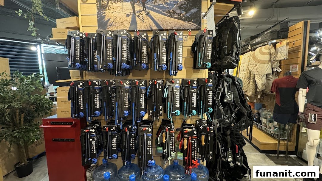 Interior view of Outdoor Life showcasing trekking poles, backpacks, and outdoor apparel displays.