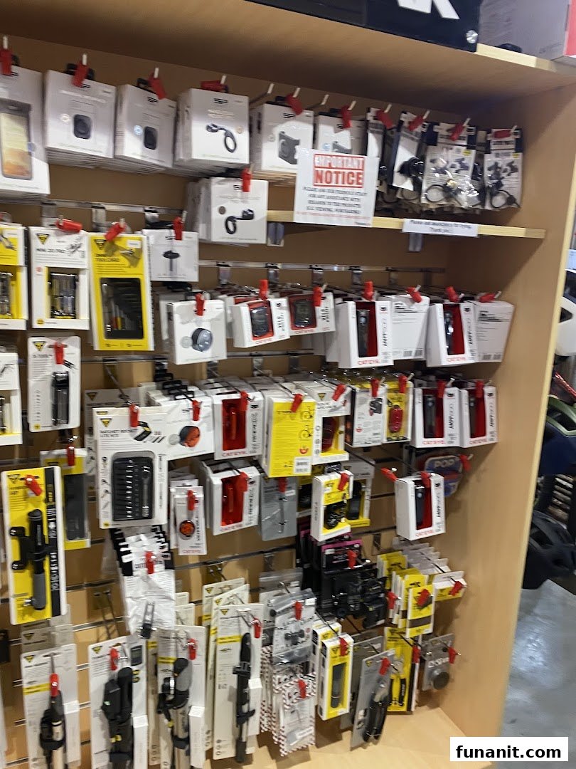 A retail display shelf showcasing various packaged outdoor and cycling accessories like tools, lights, and mounts.